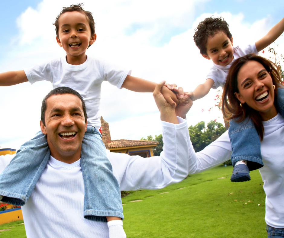 Happy Hispanic Family with children on parents shoulders